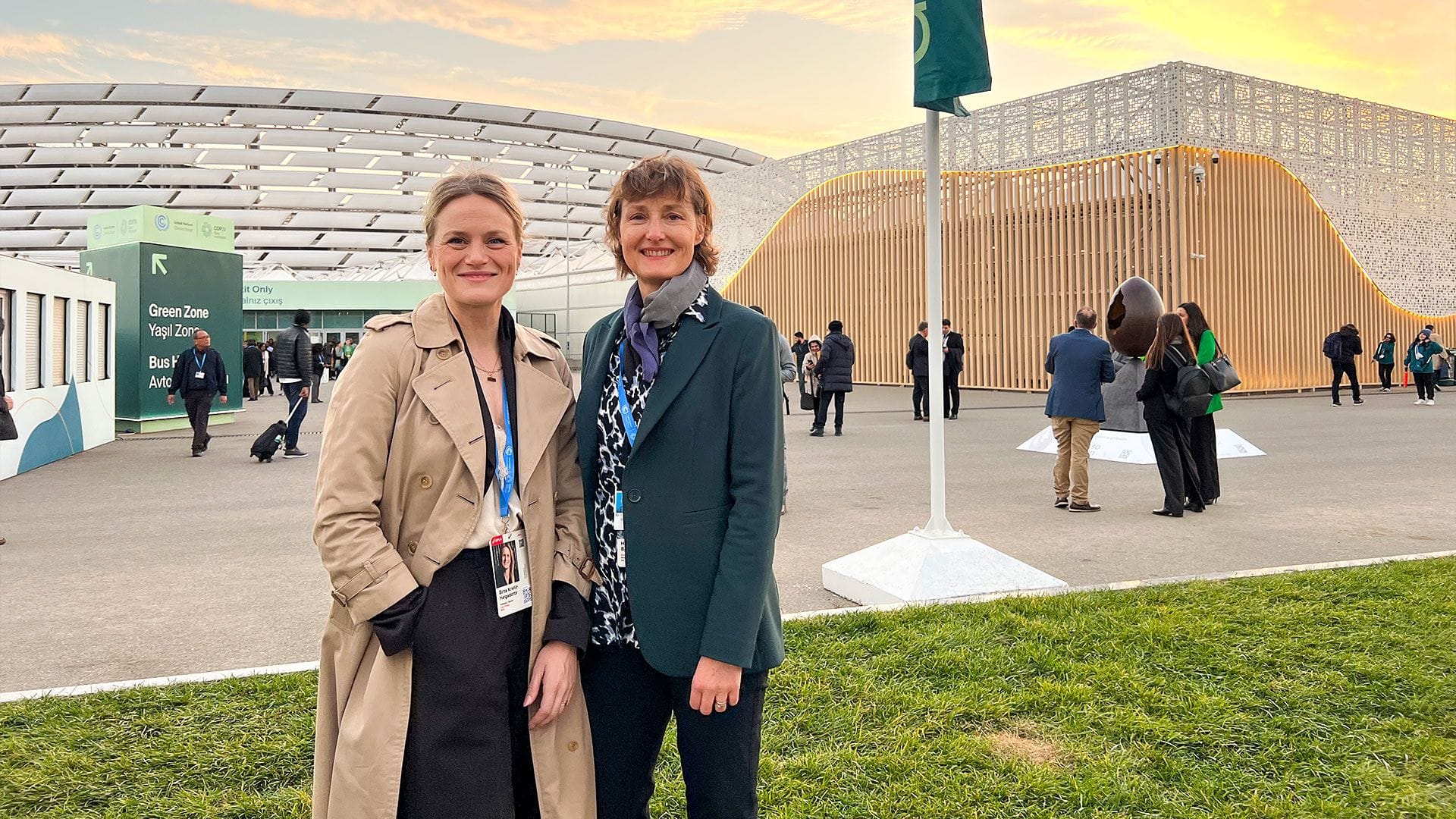 Two women in front of a conference hall.